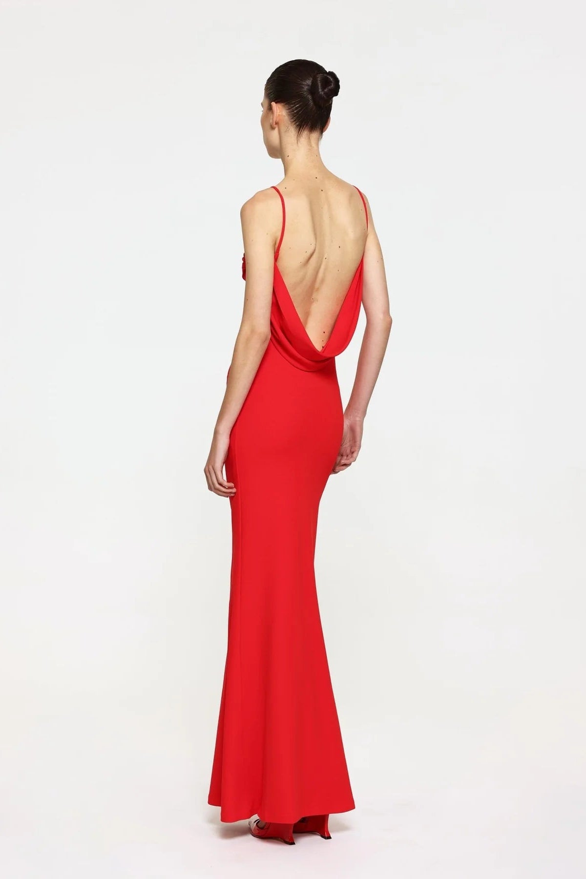 Red evening gown with a deep neckline on a white background