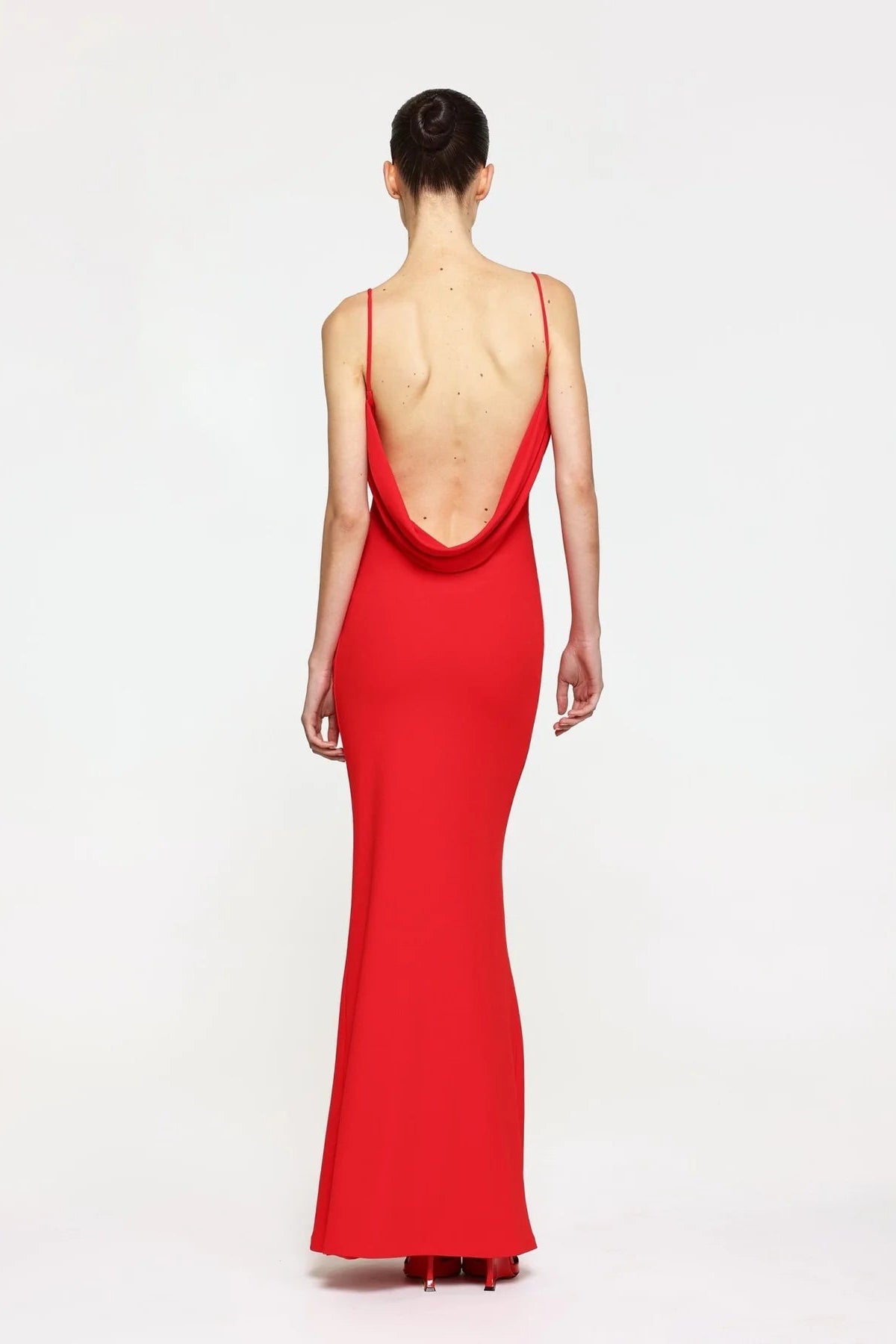Red evening gown with a deep neckline on a white background